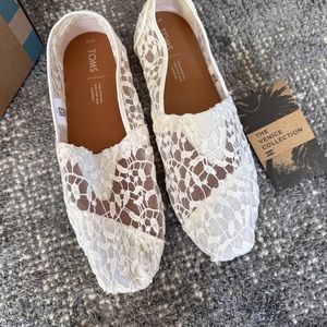 BRAND NEW Tom’s bridal white slip-ons.